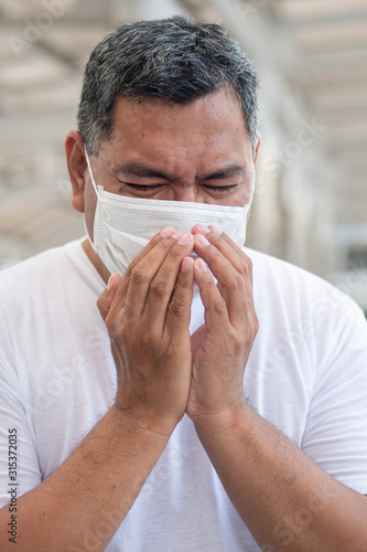 allergic sick old man coughing or sneezing with sore throat; concept of man with allergy, phlegm, sore throat or throat inflammation, influenza, flu, cold, sickness, health care concept