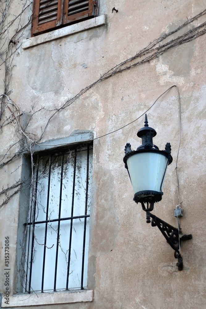 Retro style street lamp and traditional Mediterranean architecture in Split, Croatia. Selective focus.