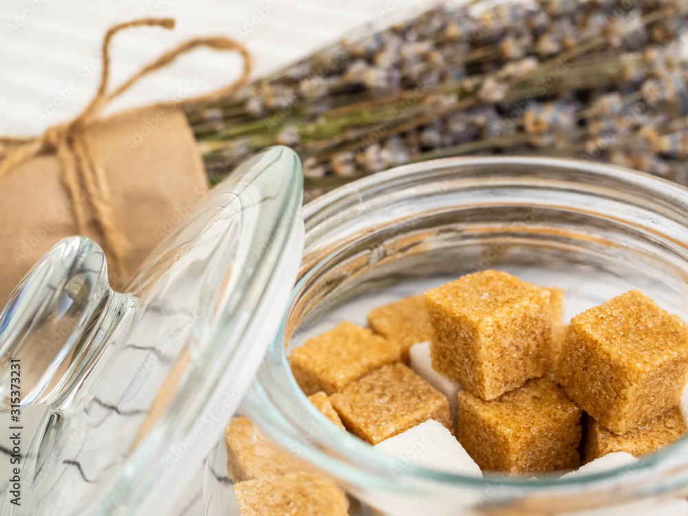 Different sugar cubes and dried lavender flowers Different sugar cubes and dried lavender flowers
