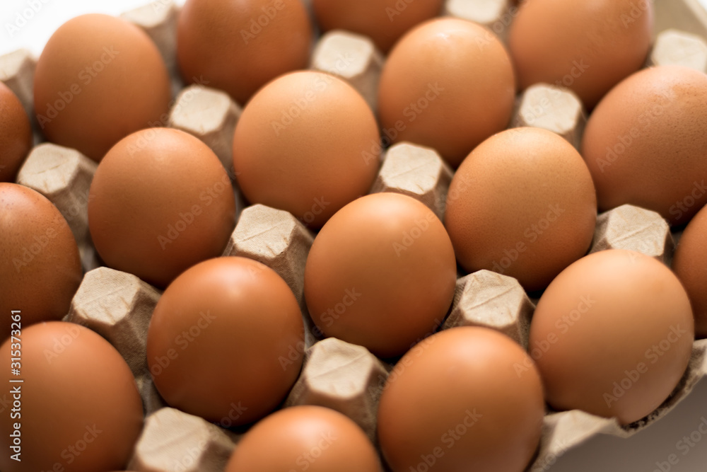 Many brown eggs in the carton background. Many brown eggs in the carton background.