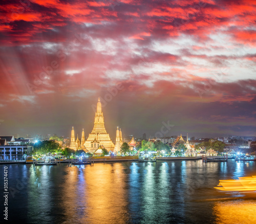 Night view of Wat Arun Ratchawararam temple. Beautiful sunset at Chao Phraya river  landmark thailand tourist spot  Bangkok - Thailand