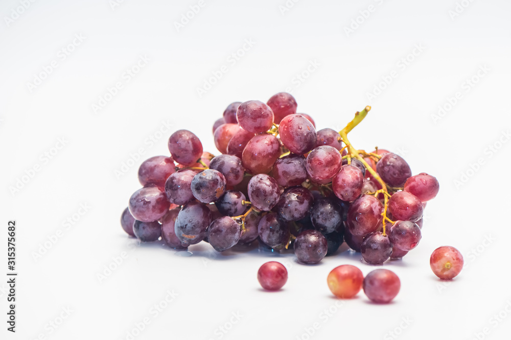 A bunch of red grapes isolated on a white background. A bunch of red grapes isolated on a white background.