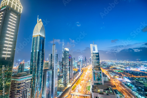 Amazing aerial view of Downtown Dubai at twilight. Skyscrapers and Sheikh Zayed Road