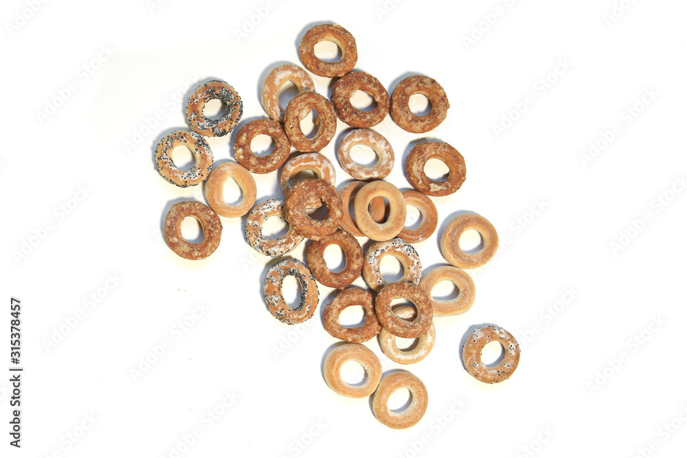 Pile of ring shaped roll cookies with different glaze isolated on white background. Bublik cookies pattern. . Pile of ring shaped roll cookies with different glaze isolated on white background. Bublik cookies pattern. .
