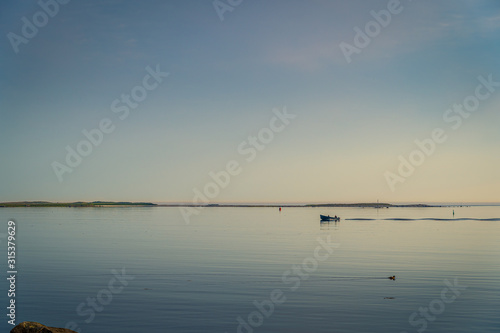 Wallpaper Mural Rocky sea coast shoreline with distant lighthouse. Torontodigital.ca