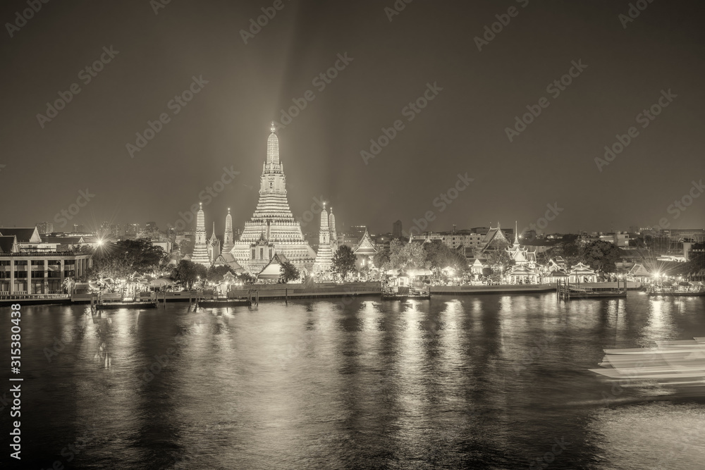 Night view of Wat Arun Ratchawararam temple. Beautiful sunset at Chao Phraya river, landmark thailand tourist spot, Bangkok - Thailand