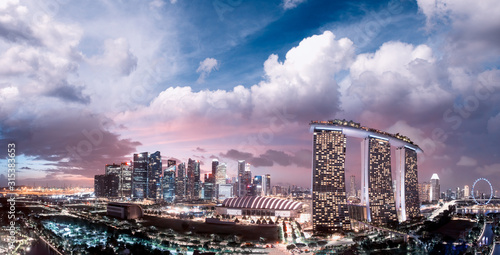 Singapore at sunset. Aerial view of Marina Bay and Downtown from drone