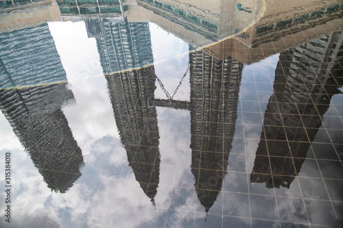 Photography Kuala Lumpur skyline reflection in a puddle, Malaysia