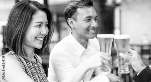 Asian friends otdoor cheering with beer glasses. Happiness, friendship and holiday concept