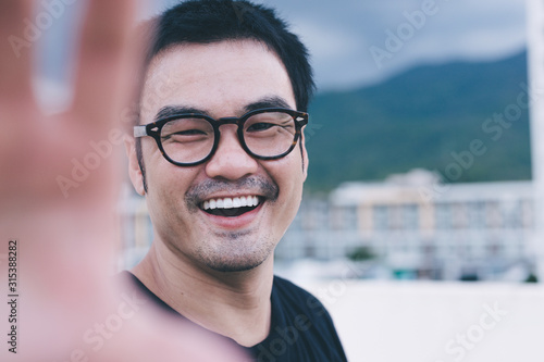 asian man smile happy enjoy taking a selfie while travelling on holiday.concept people travel outdoor adventure Free Download asian man smile happy enjoy taking a selfie while travelling on holiday.concept people travel outdoor adventure - GFXLoad