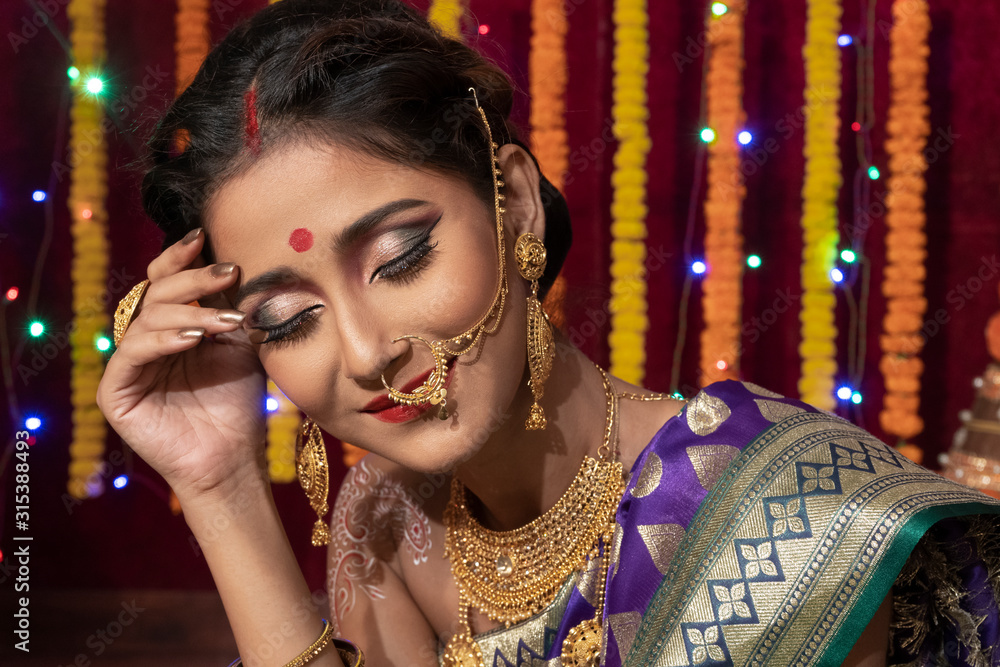 Closeup portrait of an Indian model with Bridal makeup and glossy Red lipstick And High jewelry