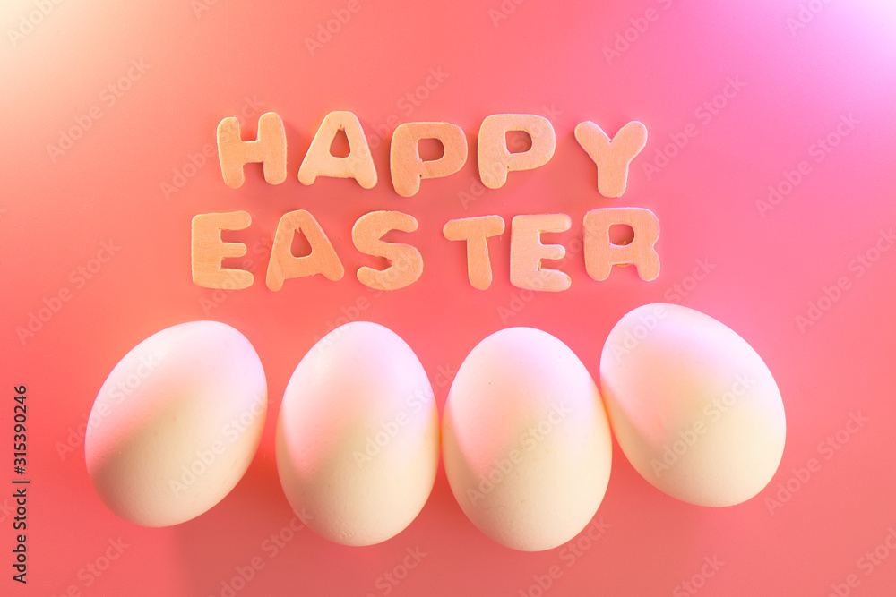 Happy easter lettering and eggs composition on festive pink background Happy easter lettering and eggs composition on festive pink background