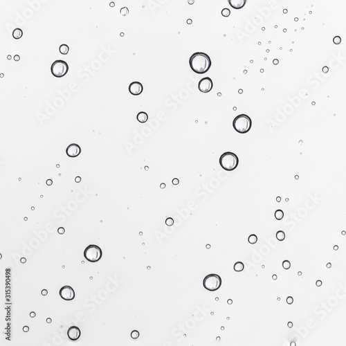 Rain water drops on clear window. Natural Pattern of raindrops. Autumn depressive background..