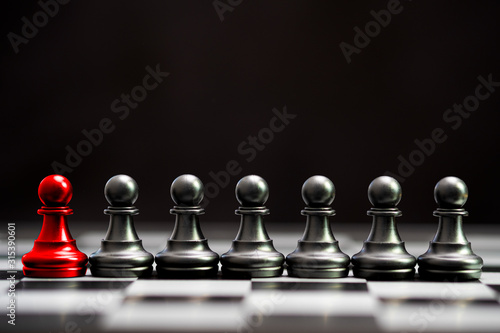 Red pawn chess with others black pawn chess for leader and different thinking.Disrupt concept.