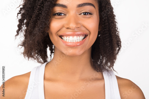 Cheerful black girl smiling and looking at camera
