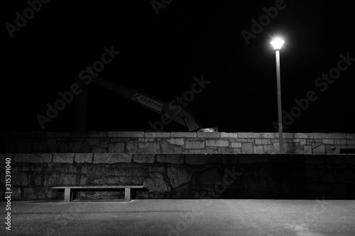 Moody Nightscape Featuring a Digger and a Bench