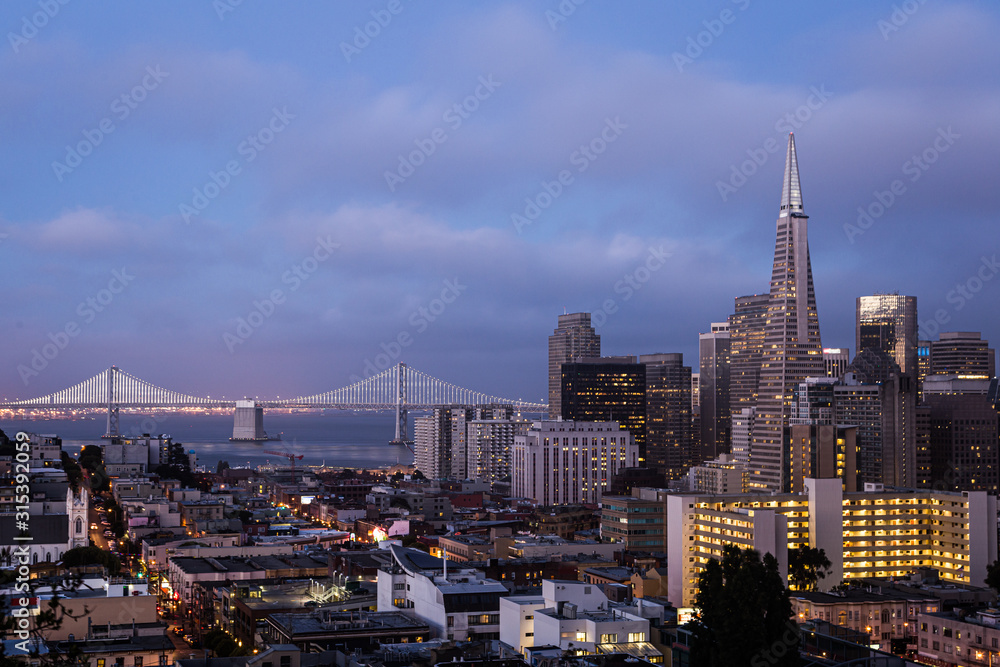 Twilight over San Francisco downtown and financial district from Russian hill with the San Francisco Auckland Bay bridge in California, USA