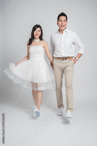 young couple Asian groom and bride in casual wedding dress walking and having fun