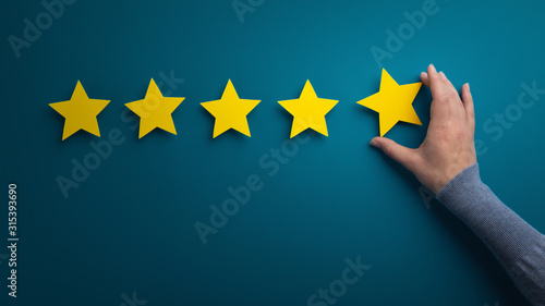 Business woman pointing five star to increase the rating