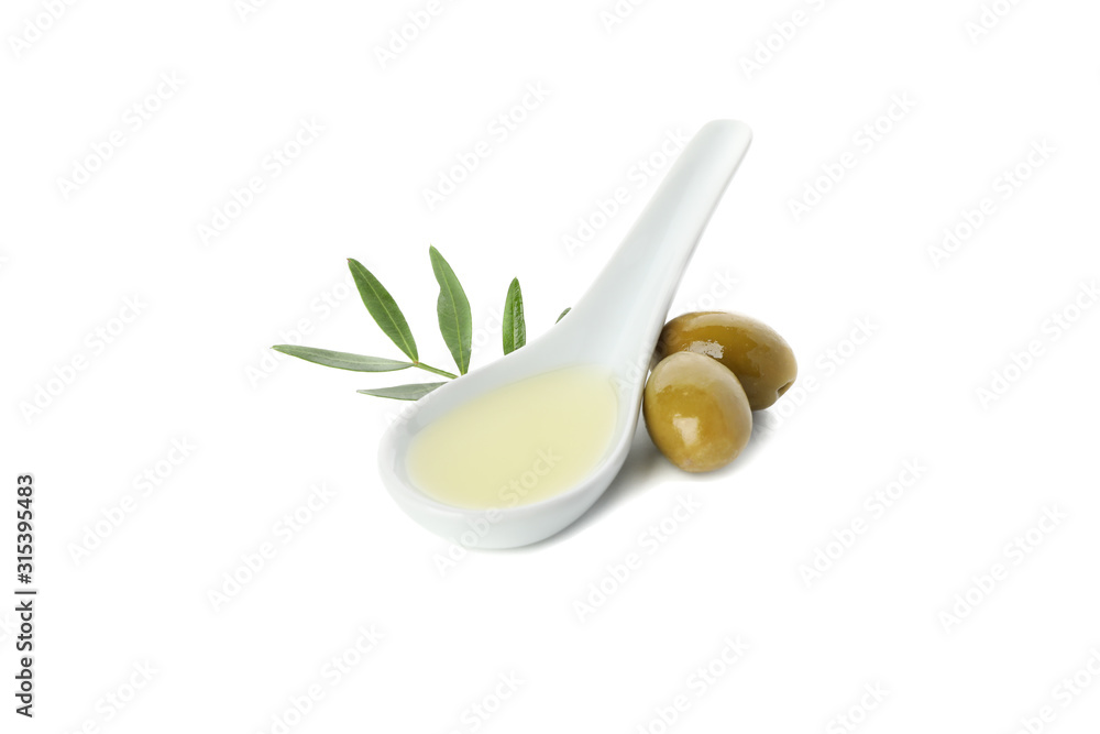 Ceramic spoon with olive oil, olives and leaves isolated on white background