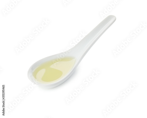 Ceramic spoon with olive oil isolated on white background