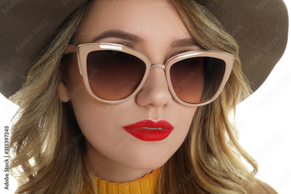 Young woman wearing stylish sunglasses and hat on white background Young woman wearing stylish sunglasses and hat on white background