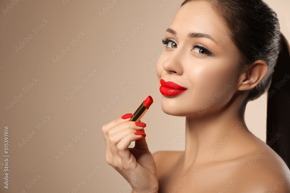 Beautiful woman with red lipstick on beige background, space for text Beautiful woman with red lipstick on beige background, space for text