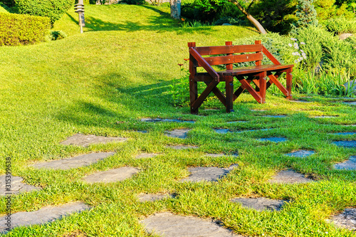 Retro style wooden bank in the backyard garden