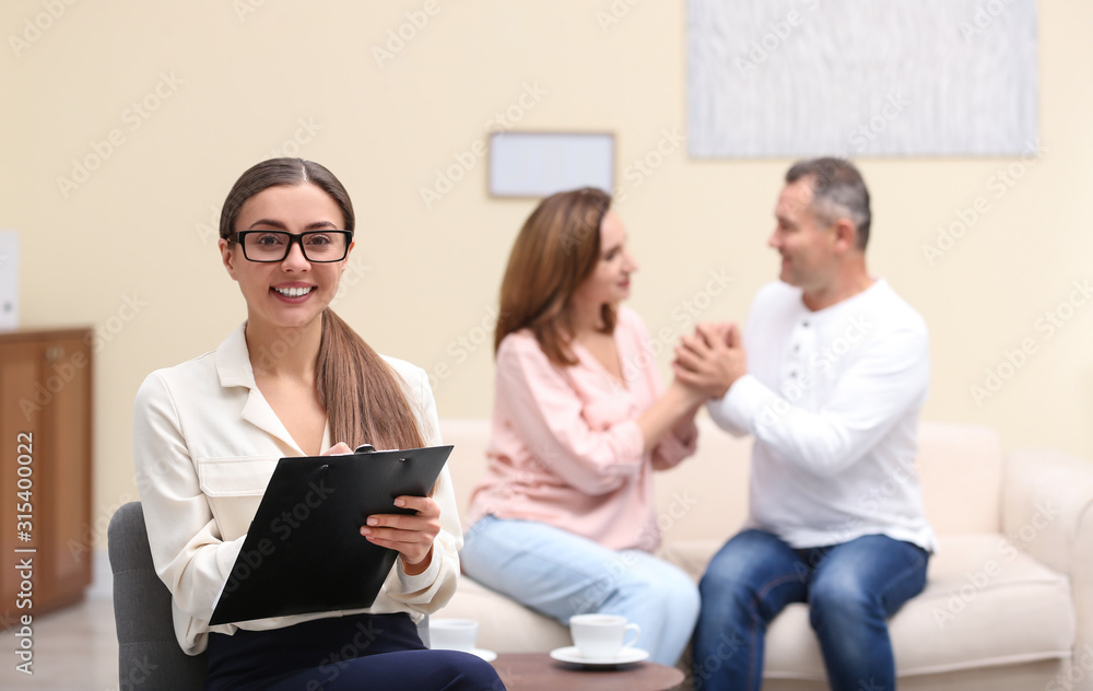 Psychotherapist and happy couple having meeting in office. Family counselling Psychotherapist and happy couple having meeting in office. Family counselling