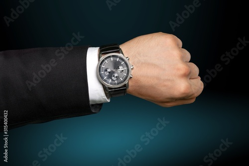 Fashion Businessman with at luxury watch. Checking the time concept.