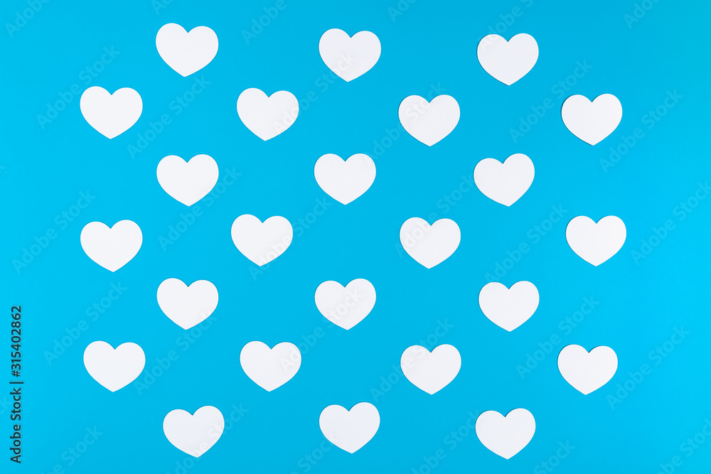 A group of white hearts placed on the blue background like a chessboard pattern A group of white hearts placed on the blue background like a chessboard pattern