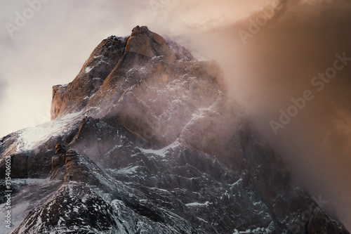 Great stony rock covered by snow in mysterious haze in Torres del Paine National Park photo