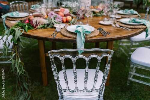 Wedding table decoration in rustic style placed outdoors