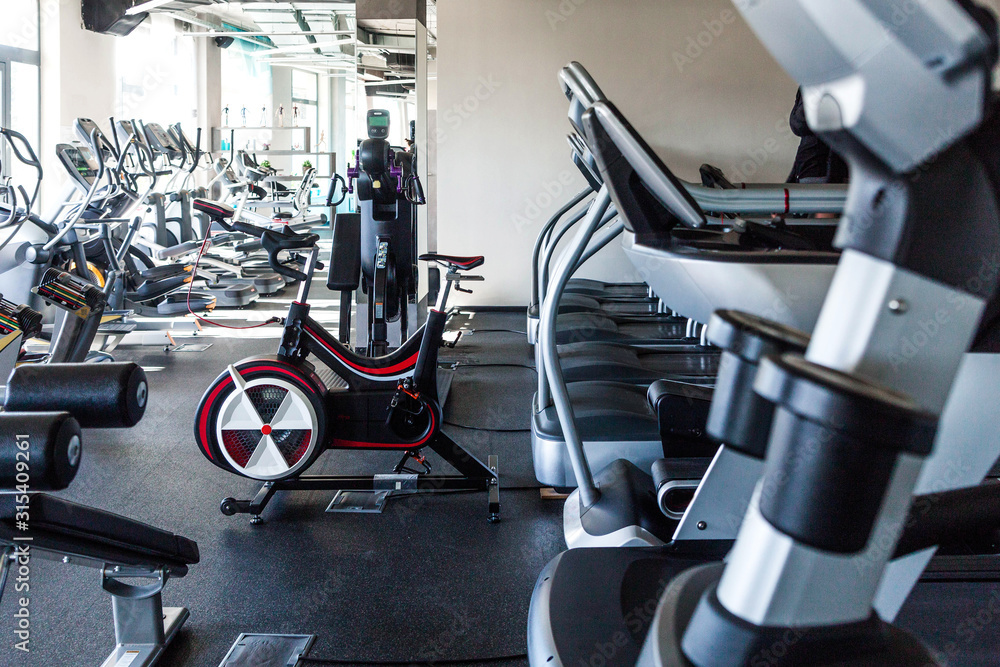 Fototapeta premium cardio and fitness equipment in gym. Good sunny weather