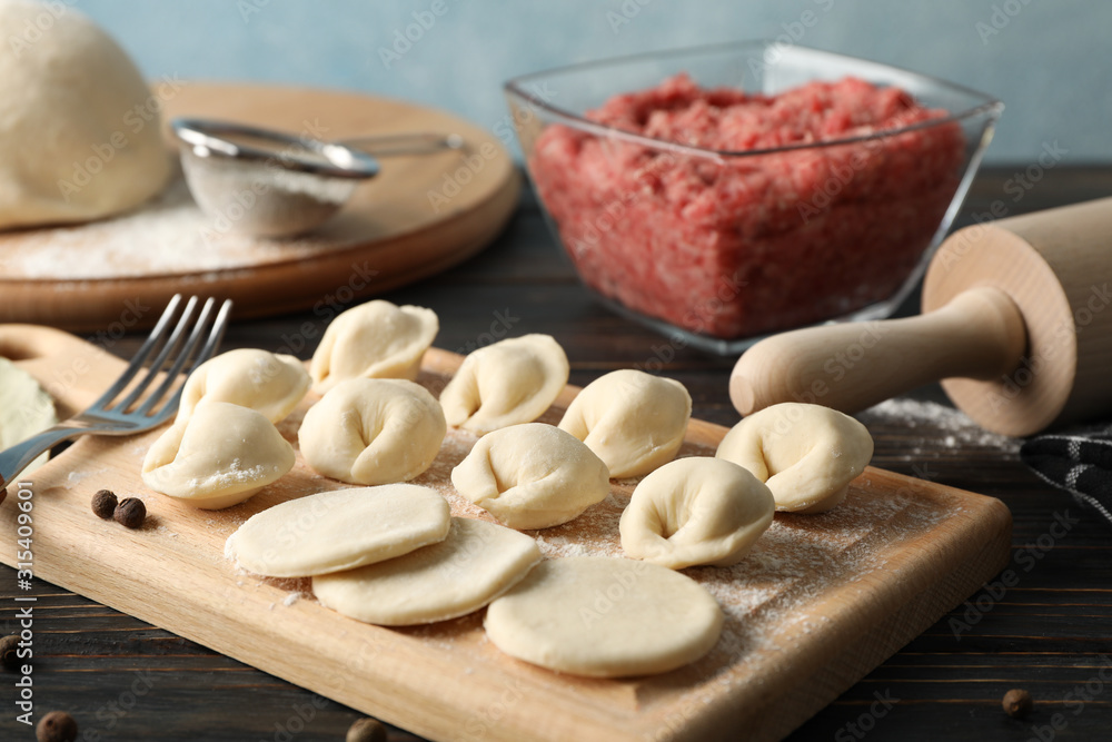 Composition with minced meat and dumplings on wooden background, close up Composition with minced meat and dumplings on wooden background, close up
