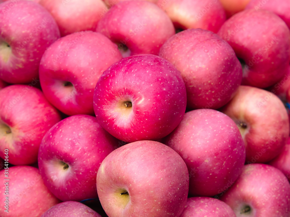 Fresh pink apples sale on the market or in the supermarket. Red apples background. Fruits and vegetables image. Fresh pink apples sale on the market or in the supermarket. Red apples background. Fruits and vegetables image.