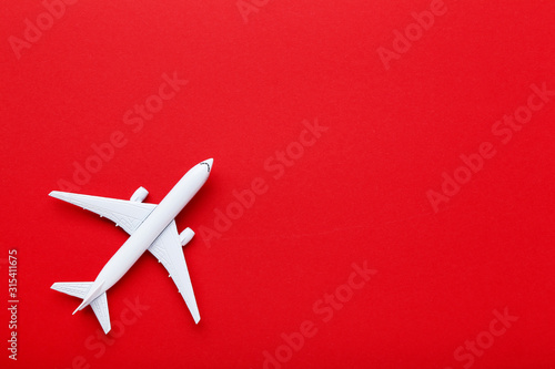 Airplane model on red paper background
