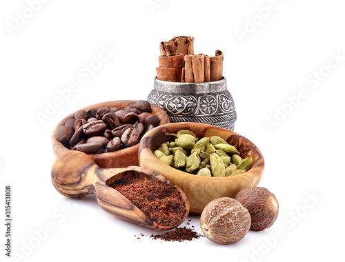 Coffee beans with cardamon, cinnamon and nutmeg  isolated on white background photo