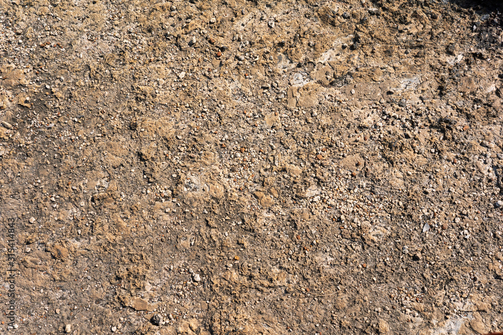 surface of the stone mountain texture and background with brown tint and gravel stones surface of the stone mountain texture and background with brown tint and gravel stones