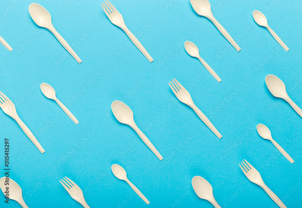 Seamless pattern of bioplastic single use cutlery isolated on blue Seamless pattern of bioplastic single use cutlery isolated on blue