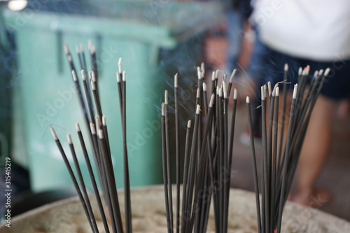 Black incense sticks lit up with smoke For Buddhists, Asia, Thailand
