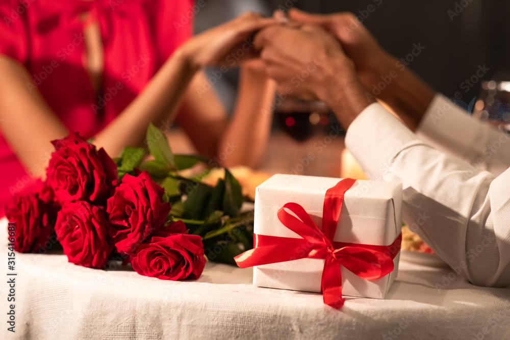 Romantic Background Of Couple Holding Hands, Gifts Lying On Table Romantic Background Of Couple Holding Hands, Gifts Lying On Table