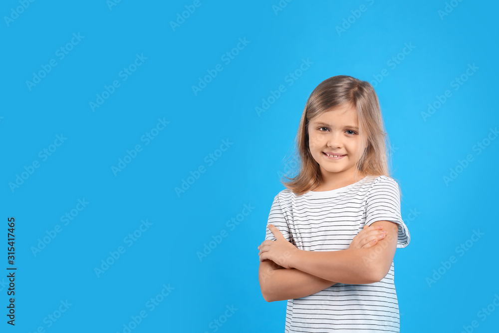 Cute little girl on light blue background. Space for text Cute little girl on light blue background. Space for text