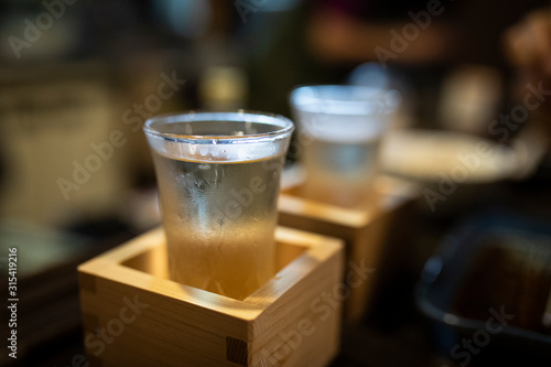 Japan, Takayama, Sake served in masu in traditional Japanese restaurant photo