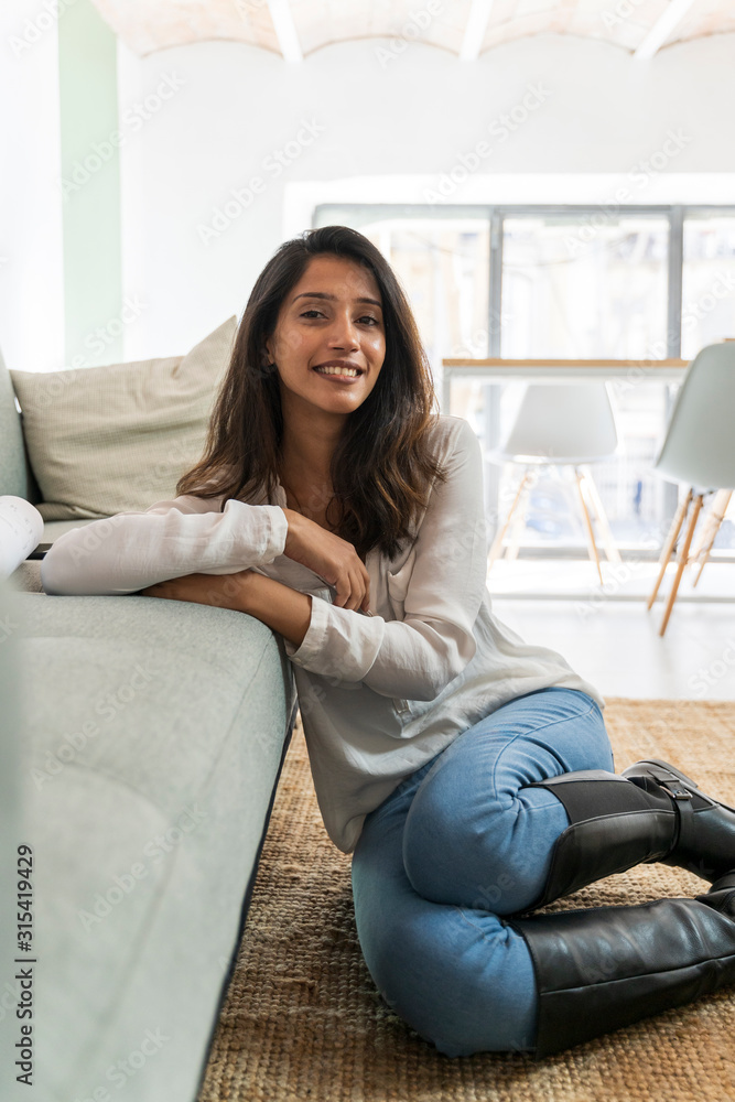 Young indian woman sitting on the floor, looking at camera Young indian woman sitting on the floor, looking at camera