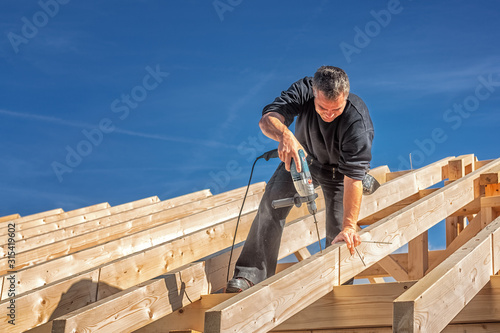 Carpenter at Work, Fixing a Rafter with a Long Screw