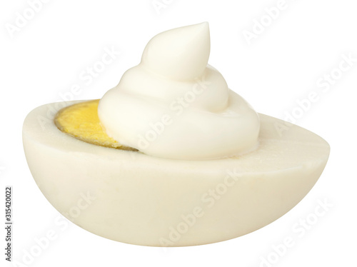Half egg with mayonnaise isolated on white background. Close up.