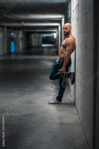 Wallpaper Mural Barechested muscular athlete with rope leaning on wall Torontodigital.ca