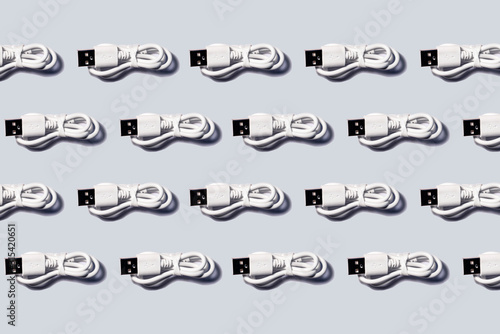 3D Illustration, white USB cables in a row on gray background