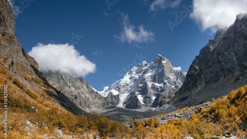 Snow peak of Ushba mountain in Svaneti. Georgia. The Greater Caucasus Range in Autumn
